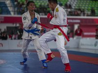 Aceh Province Ju-Jitsu athlete Aldo Afriansyah competes against Central Java Ju-Jitsu athlete Yulianto (Blue) in the men's fighting system -...