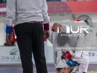 East Java Jiu-jitsu athlete Artz Brilliant Perfecto (Red) competes against North Sumatra contingent athlete Ronaldo Sagala (Blue) in the Fig...