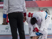 East Java Jiu-jitsu athlete Artz Brilliant Perfecto (Red) competes against North Sumatra contingent athlete Ronaldo Sagala (Blue) in the Fig...