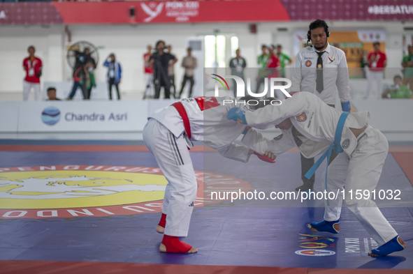 East Java Jiu-jitsu athlete Artz Brilliant Perfecto (Red) competes against North Sumatra contingent athlete Ronaldo Sagala (Blue) in the Fig...