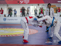 East Java Jiu-jitsu athlete Artz Brilliant Perfecto (Red) competes against North Sumatra contingent athlete Ronaldo Sagala (Blue) in the Fig...