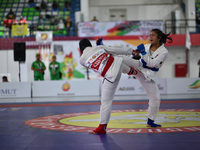 Female Jiu-Jitsu athlete from North Sumatra (Red), Suci Anggi Harum, competes against West Java contingent athlete, Octi Putri (Blue), in th...