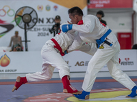 Aceh Jiu Jitsu athlete Aldo Alfriansyah (Blue) competes against an athlete from the West Java contingent, Handoko Wahyu (Red), in the men's...