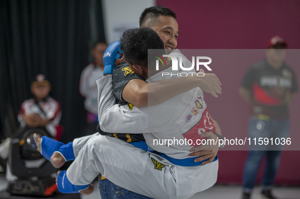 Jiu Jitsu athlete Aldo Alfriansyah (Blue) is euphoric after his victory against West Java contingent athlete Handoko Wahyu (Red) in the Figh...