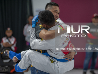 Jiu Jitsu athlete Aldo Alfriansyah (Blue) is euphoric after his victory against West Java contingent athlete Handoko Wahyu (Red) in the Figh...