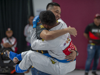 Jiu Jitsu athlete Aldo Alfriansyah (Blue) is euphoric after his victory against West Java contingent athlete Handoko Wahyu (Red) in the Figh...