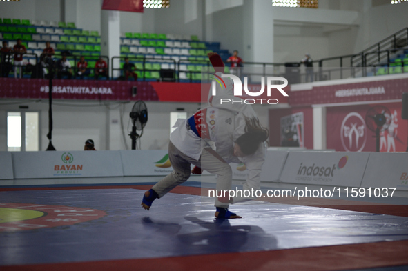 Linda Darrow, an Acehnese Jiu Jitsu athlete (Blue), competes against Tifanny Sie, an athlete from the DKI Jakarta contingent (Red), in the w...