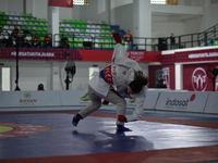 Linda Darrow, an Acehnese Jiu Jitsu athlete (Blue), competes against Tifanny Sie, an athlete from the DKI Jakarta contingent (Red), in the w...