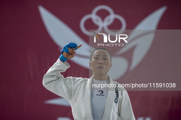 Linda Darrow, an Aceh Jiu Jitsu athlete, competes against Tifanny Sie from the DKI Jakarta contingent in the Fighting System -55 kg women's...