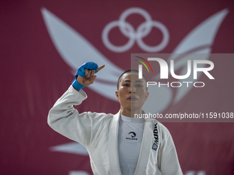 Linda Darrow, an Aceh Jiu Jitsu athlete, competes against Tifanny Sie from the DKI Jakarta contingent in the Fighting System -55 kg women's...