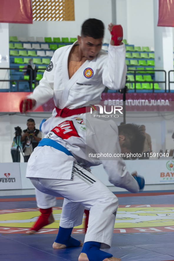 Jiu Jitsu athlete from East Java, Artz Brilliant (Blue), competes against an athlete from the East Kalimantan contingent, M Irfan Fauzi (Red...