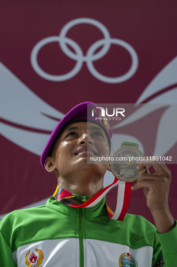 Raihan Syauqi, a Jiu-jitsu athlete from North Sumatra, poses with his silver medal after winning the men's -77 kg fighting system class at t...