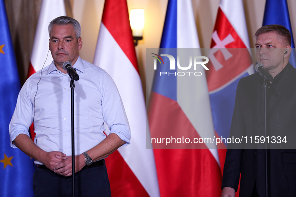 Slovak Prime Minister Robert Fico (R) with Austrian Chancellor Karl Nehammer (L) during a meeting with Polish Prime Minister Donald Tusk, EC...