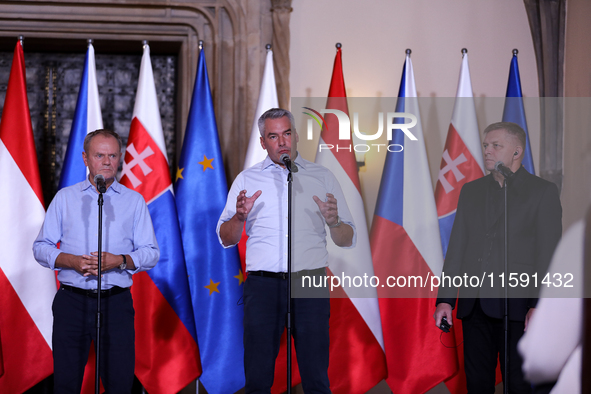 Polish Prime Minister Donald Tusk (L) with Austrian Chancellor Karl Nehammer (C) and Slovak Prime Minister Robert Fica (R) during a meeting...