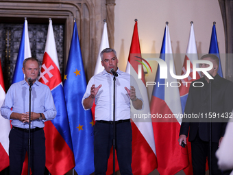 Polish Prime Minister Donald Tusk (L) with Austrian Chancellor Karl Nehammer (C) and Slovak Prime Minister Robert Fica (R) during a meeting...