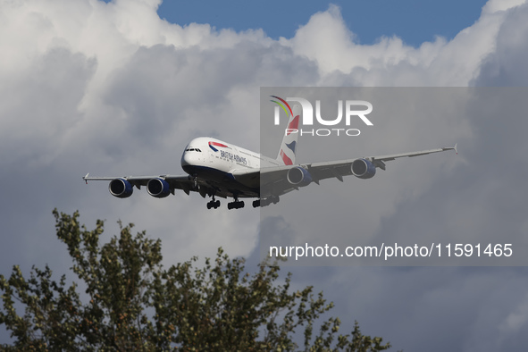 British Airways Airbus A380 Superjumbo passenger aircraft, spotted flying on final approach for landing on London Heathrow Airport runway in...