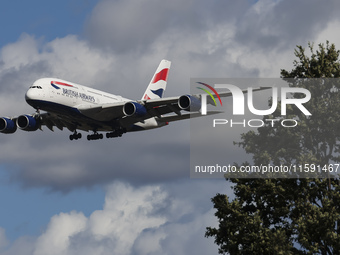 British Airways Airbus A380 Superjumbo passenger aircraft, spotted flying on final approach for landing on London Heathrow Airport runway in...