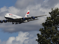 British Airways Airbus A380 Superjumbo passenger aircraft, spotted flying on final approach for landing on London Heathrow Airport runway in...