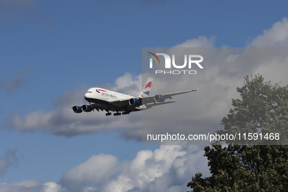 British Airways Airbus A380 Superjumbo passenger aircraft, spotted flying on final approach for landing on London Heathrow Airport runway in...