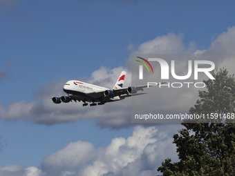 British Airways Airbus A380 Superjumbo passenger aircraft, spotted flying on final approach for landing on London Heathrow Airport runway in...