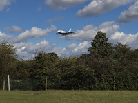 British Airways Airbus A380 Superjumbo passenger aircraft, spotted flying on final approach for landing on London Heathrow Airport runway in...