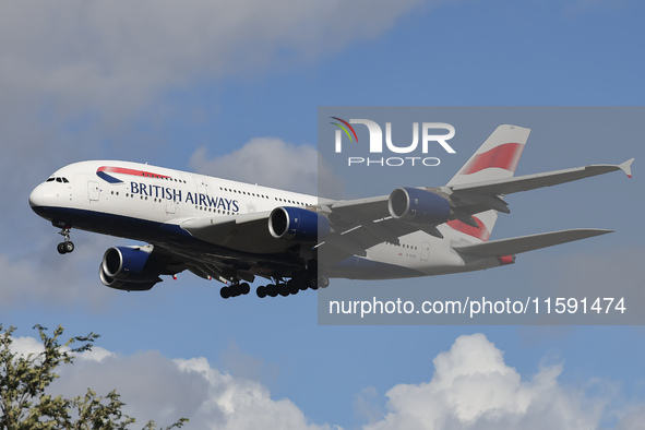 British Airways Airbus A380 Superjumbo passenger aircraft, spotted flying on final approach for landing on London Heathrow Airport runway in...