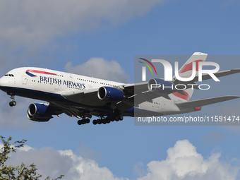 British Airways Airbus A380 Superjumbo passenger aircraft, spotted flying on final approach for landing on London Heathrow Airport runway in...