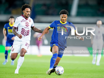 Amin Sarr of Hellas Verona and Valentino Lazaro of Torino FC compete for the ball during the Serie A Enilive match between Hellas Verona and...