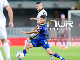 Reda Belahyane of Hellas Verona and Antonio Sanabria of Torino FC compete for the ball during the Serie A Enilive match between Hellas Veron...