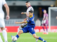 Reda Belahyane of Hellas Verona and Antonio Sanabria of Torino FC compete for the ball during the Serie A Enilive match between Hellas Veron...