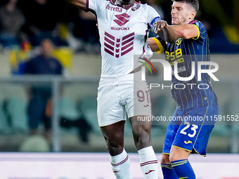 Duvan Zapata of Torino FC and Giangiacomo Magnani of Hellas Verona compete for the ball during the Serie A Enilive match between Hellas Vero...