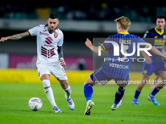 Antonio Sanabria of Torino FC and Martin Frese of Hellas Verona compete for the ball during the Serie A Enilive match between Hellas Verona...