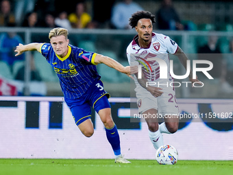 Martin Frese of Hellas Verona and Valentino Lazaro of Torino FC compete for the ball during the Serie A Enilive match between Hellas Verona...