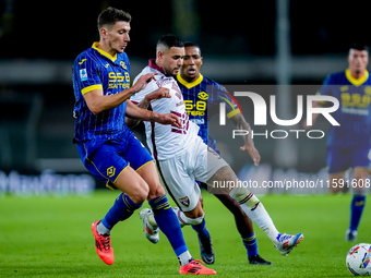 Antonio Sanabria of Torino FC and Giangiacomo Magnani of Hellas Verona compete for the ball during the Serie A Enilive match between Hellas...