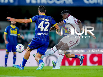 Duvan Zapata of Torino FC and Diego Coppola of Hellas Verona during the Serie A Enilive match between Hellas Verona and Torino FC at Stadio...