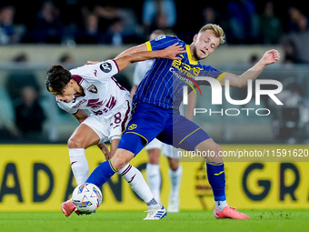 Samuele Ricci of Torino FC and Casper Tendstedt of Hellas Verona compete for the ball during the Serie A Enilive match between Hellas Verona...