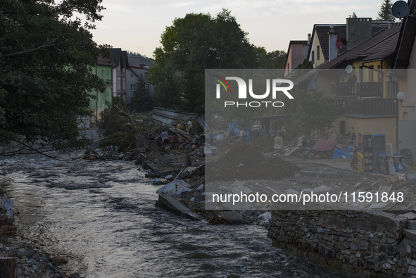 Morawka river flows by debris and damaged houses left by the flood in Stronie Slaskie, Poland on September 20, 2024. 