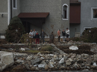 People talk outside their damaged house after a flood hit the town of Stronie Slaskie, Poland on September 20, 2024. (