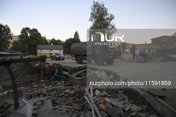 A truck of the Polish armed forces passes by debris left by flood waters in Stronie Slaskie, Poland on September 20, 2024. 