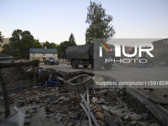 A truck of the Polish armed forces passes by debris left by flood waters in Stronie Slaskie, Poland on September 20, 2024. (