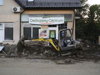 A man removes debris left by the flood wave in Stronie Slaskie, Poland on September 20, 2024. (