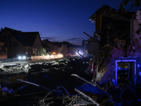 Cars pass by damaged buildings at sunset after a flood hit the town of  Stronie Slaskie, Poland on September 20, 2024. (