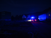 Police pass by damaged buildings and debris after a flood hit the town of  Stronie Slaskie, Poland on September 20, 2024. (