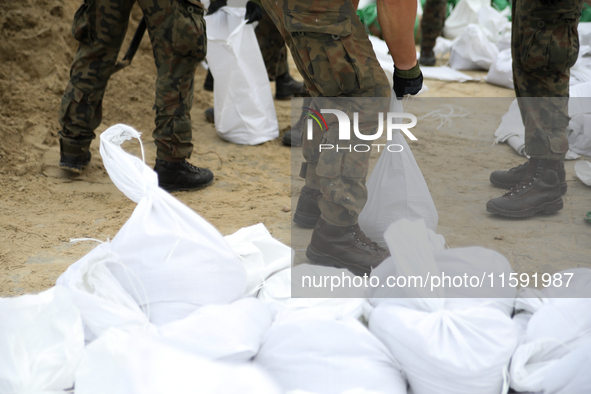 Soldiers from the 1st Brzeg Sapper Regiment prepare sandbags during flooding due to the Odra River flooding in Brzeg, Poland, on September 1...