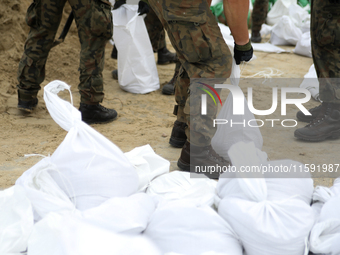 Soldiers from the 1st Brzeg Sapper Regiment prepare sandbags during flooding due to the Odra River flooding in Brzeg, Poland, on September 1...