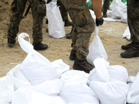 Soldiers from the 1st Brzeg Sapper Regiment prepare sandbags during flooding due to the Odra River flooding in Brzeg, Poland, on September 1...