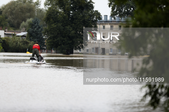 A rescuer with a motorboat operates in flooded areas of the city due to the flooding of the Odra River in Brzeg, Poland, on September 19, 20...