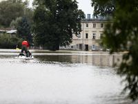 A rescuer with a motorboat operates in flooded areas of the city due to the flooding of the Odra River in Brzeg, Poland, on September 19, 20...