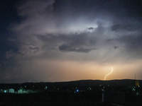 A lightning bolt illuminates the sky over northwest Syria, above the refugee camps, on September 20, 2024. The horizon flashes with the ligh...