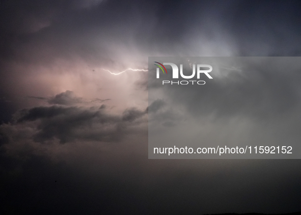 A lightning bolt illuminates the sky over northwest Syria, above the refugee camps, on September 20, 2024. The horizon flashes with the ligh...